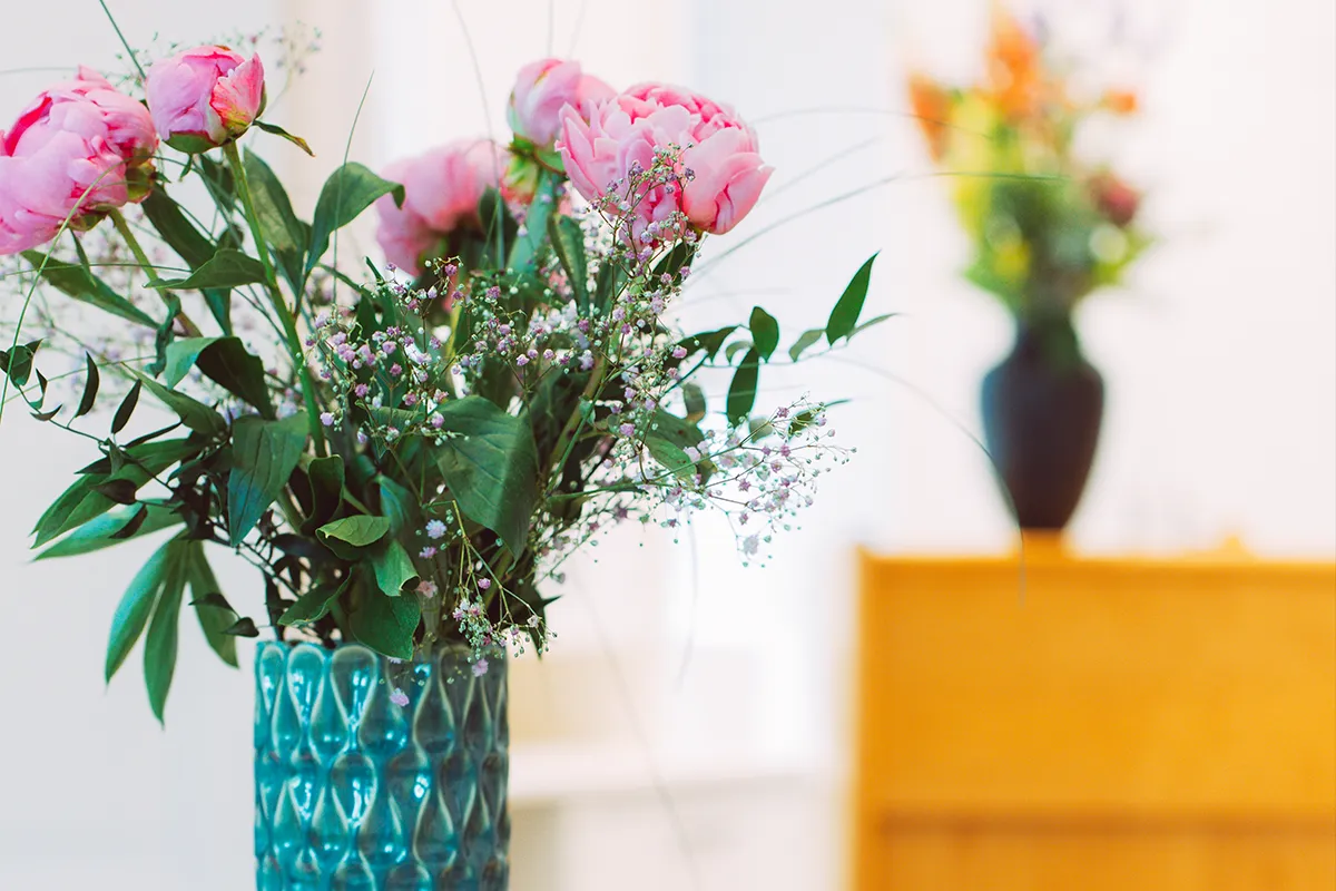 Rose flower in turquoise vase